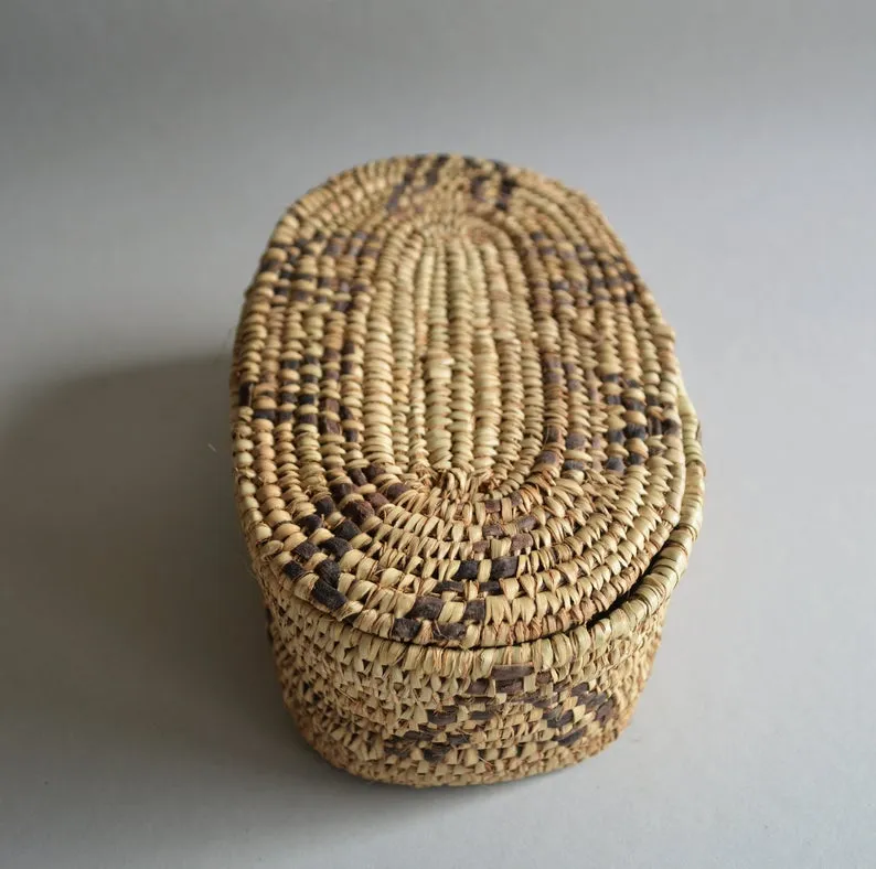 Oval box for jewelry from palm leaves and leather